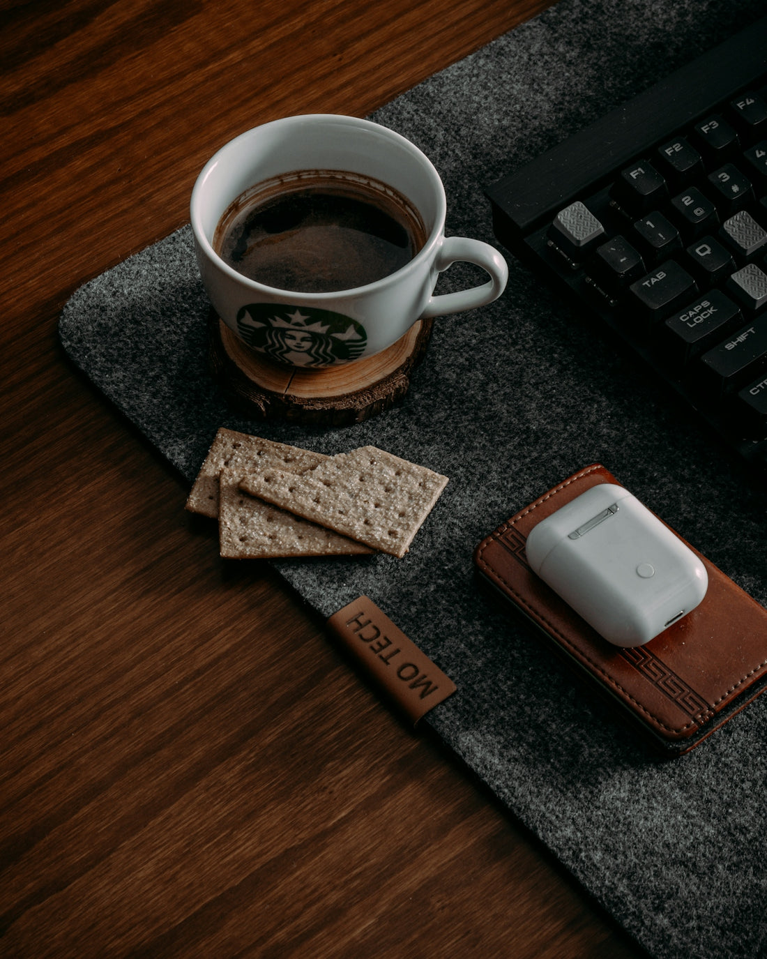 a cup of coffee and a cell phone on a desk