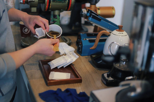 person pouring powder in cup