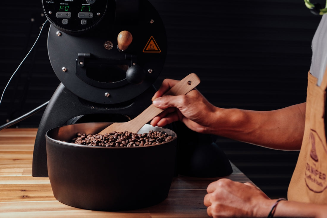 a person holding a wood spoon over a pot of food