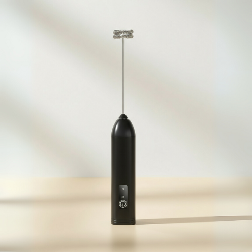Modern black milk frother with stainless steel whisk, designed for stylish and efficient frothing